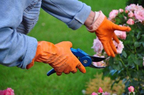 Worker wearing full PPE while operating gardening equipment