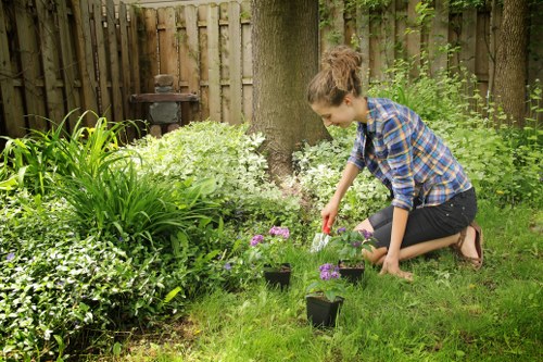 Volunteers and charity partners collecting salvageable garden materials